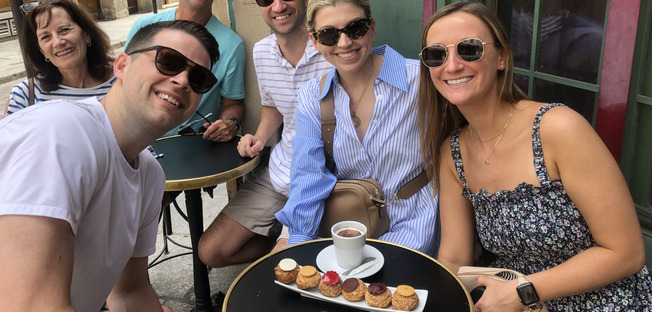 the guest are happy savouring a creampuff at odette the pastry shop is next to notre dame