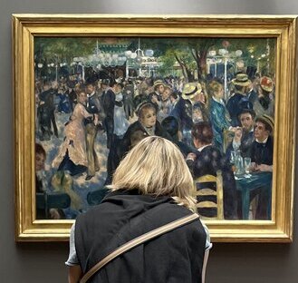 someone sitting in front of the painting: le bal du moulin de la galette by Renoir