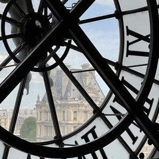 orsay top floor clock with the view of the Louvre