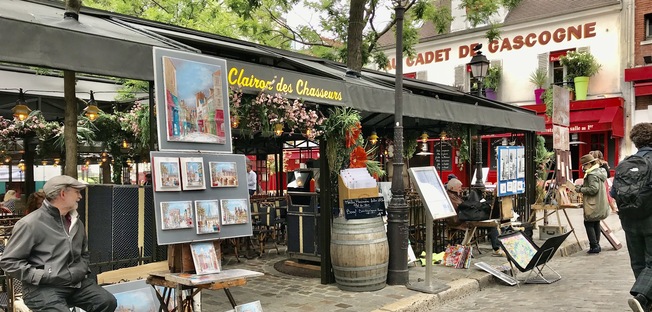 place du tertre in montmartre, there is a local street painter on the left handside of the painting, the overall feel is very charming