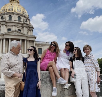 a family stopped at the Invalides enjoying a good laughter in front of napoleon's grave