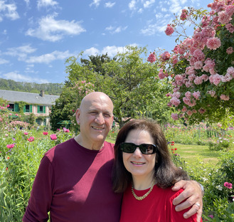 couple smiling in the gardens of monet