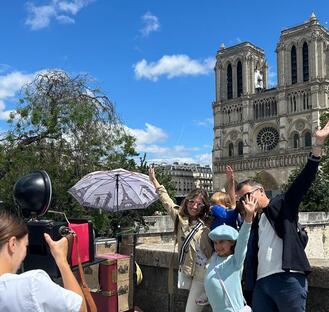 family taking a vintage picture in front of Notre dame