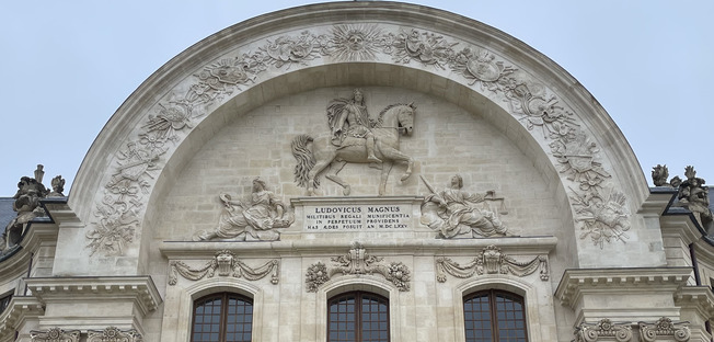 Entrance to the Invalides with the great arch under the bas relief of Louis XIV