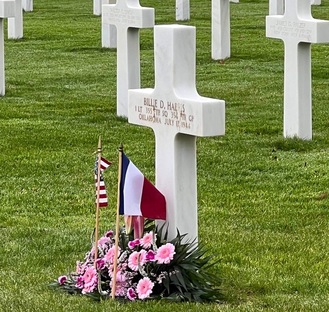 tomb of fallen soldier with the sand of omaha beach as a sympbol on it