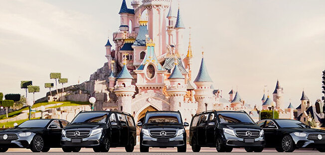 a collection of cars in front of the castle of disneyland Paris